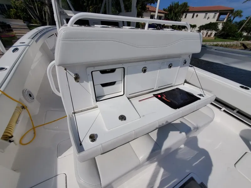 Slide: The Image of 2019 Invincible 39 CC boat with white seating and storage compartments. - 29