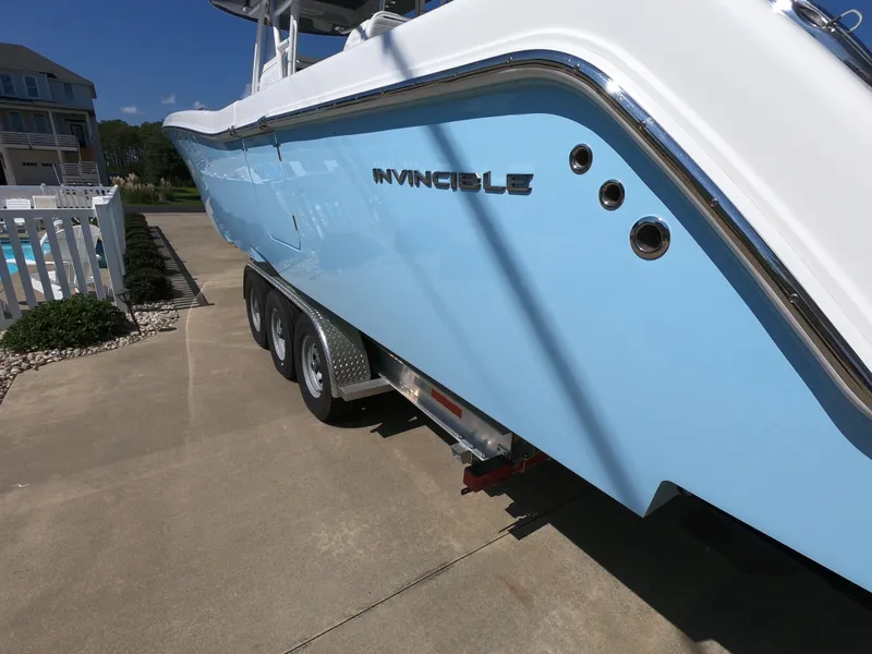 Slide: The Image of 2019 Invincible 39 CC boat on trailer, light blue hull, parked outdoors. - 5