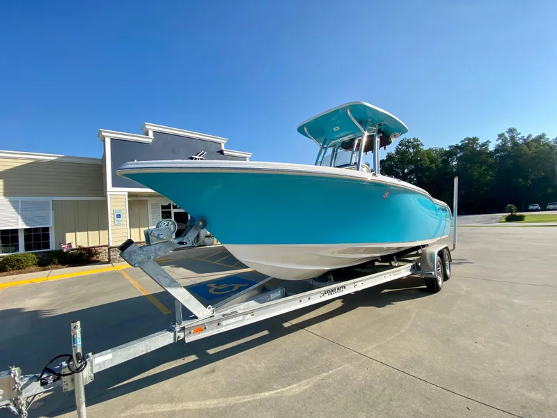 Slide: The Image of 2023 Key West 239 FS boat on a trailer in a parking lot. - 1