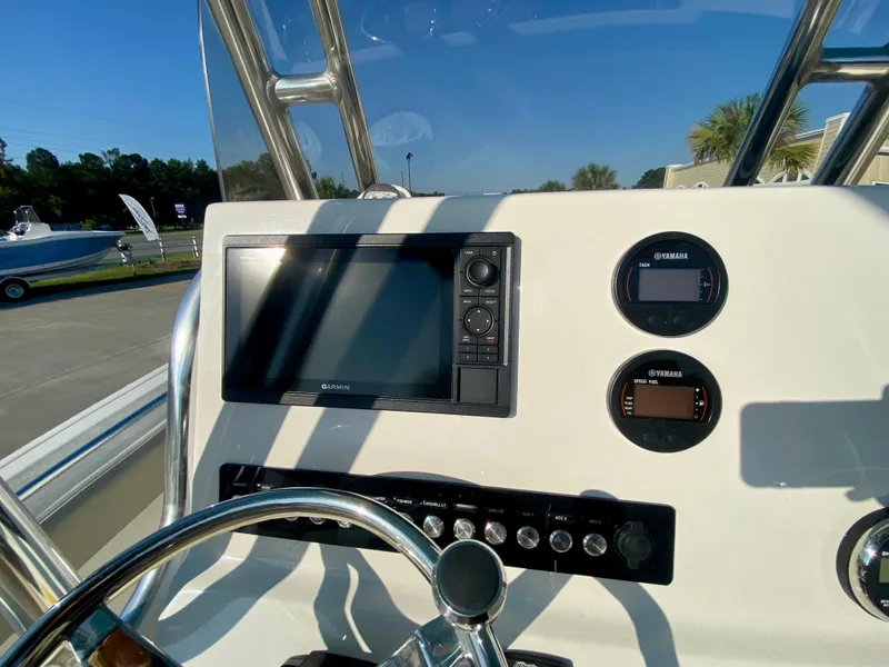 Slide: The Image of 2023 Key West 239 FS boat dashboard with navigation and control instruments. - 13