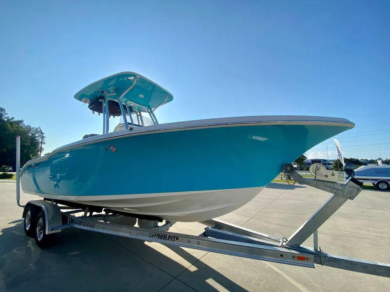 Slide: The Image of 2023 Key West 239 FS boat on a trailer in a parking lot. - 2