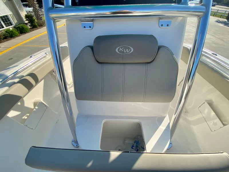 Slide: The Image of 2023 Key West 239 FS boat interior with cushioned seating and storage compartment. - 20