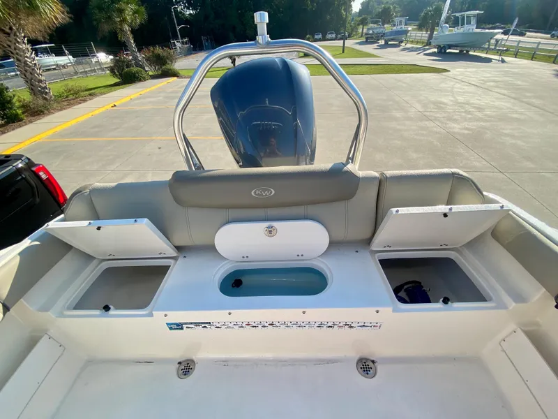 Slide: The Image of 2023 Key West 239 FS boat stern with storage compartments and outboard motor. - 9
