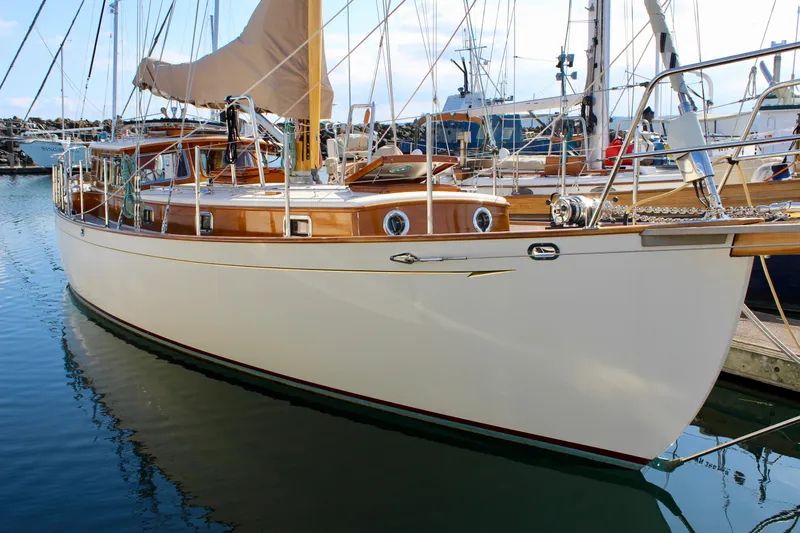 The Image of 2018 Cape George 45 sailboat docked in marina, featuring classic wooden design and sleek hull. - 0