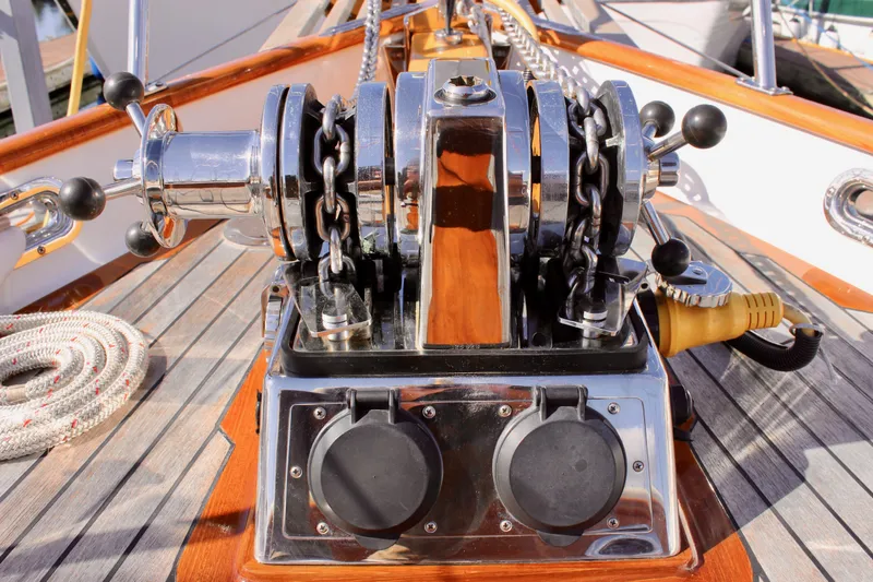 Slide: The Image of Anchor windlass on 2018 Cape George 45 sailboat deck, featuring polished metal and wooden accents. - 13