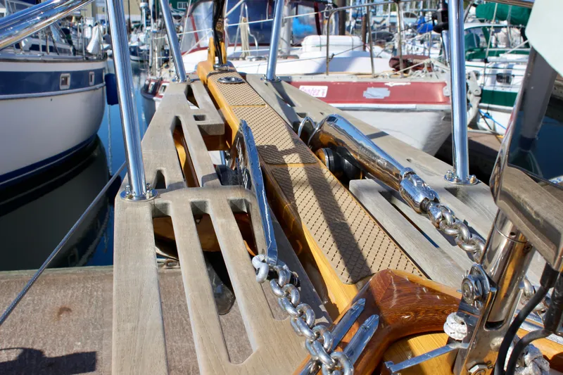 Slide: The Image of Cape George 45 sailboat deck with polished fittings and wooden accents, 2018 model. - 14
