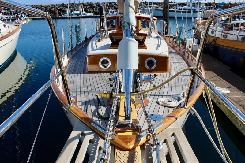 Slide: The Image of Cape George 45 sailboat, 2018 model, docked in a marina, showcasing its deck and bow. - 15