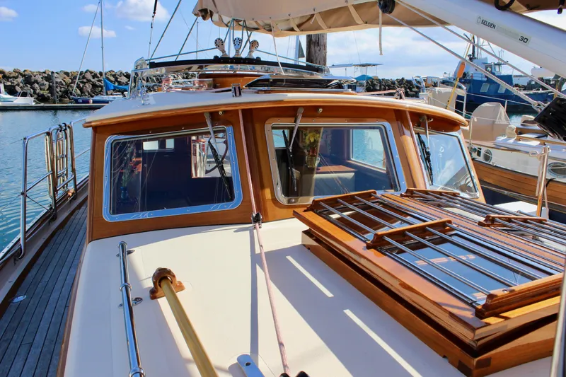 Slide: The Image of Sailboat Cape George 45, 2018 model, docked with wooden deck and cabin details. - 17