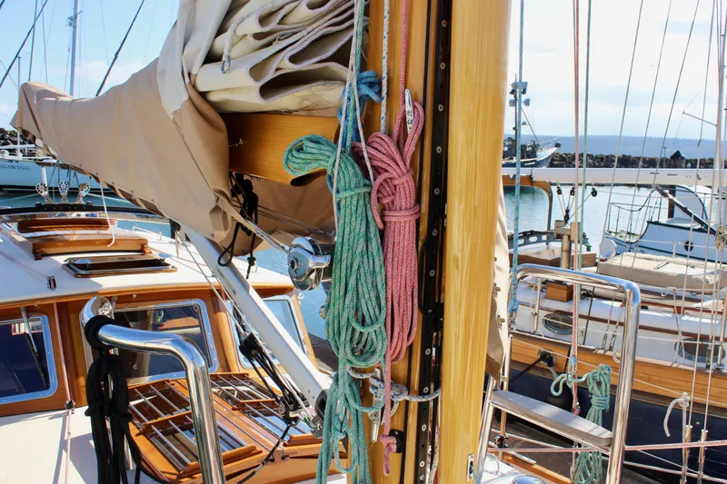 Slide: The Image of Cape George 45 sailboat deck with ropes and mast, docked in a marina, 2018 model. - 19