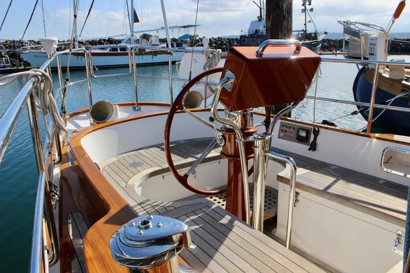 Slide: The Image of Cockpit of 2018 Cape George 45 sailboat with wooden accents and steering wheel in marina. - 22