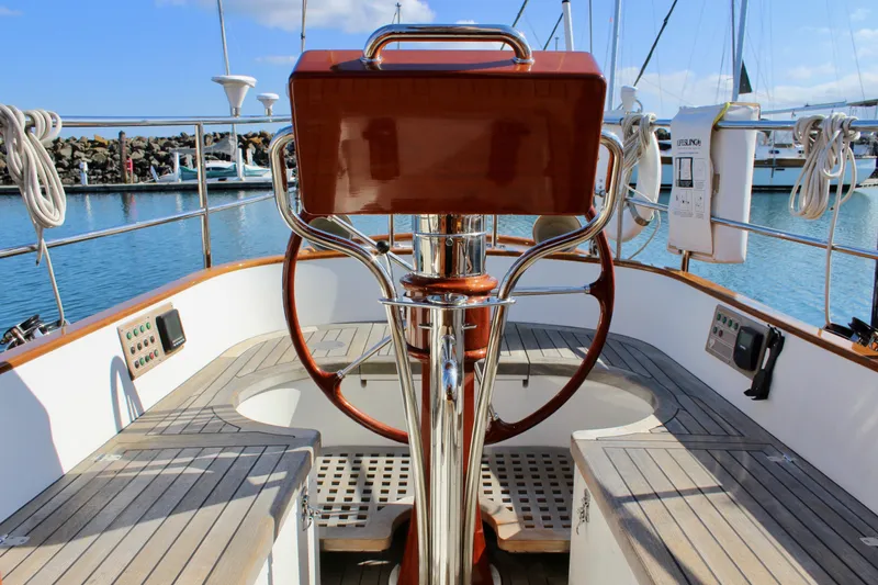 Slide: The Image of Cockpit of 2018 Cape George 45 sailboat with wooden wheel and nautical controls. - 23