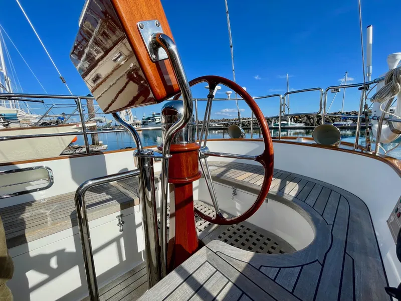 Slide: The Image of Cockpit of 2018 Cape George 45 sailboat with wooden wheel and polished metal details. - 27