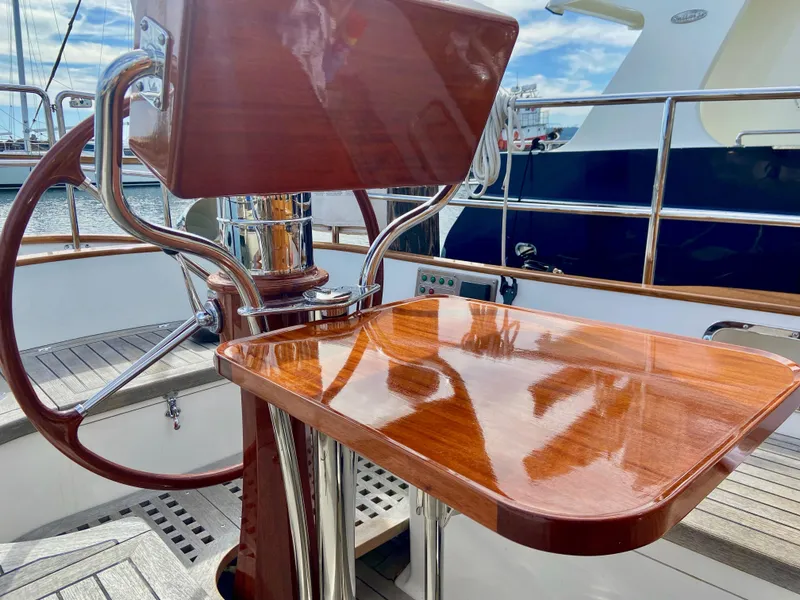 Slide: The Image of Elegant wooden helm station on a 2018 Cape George 45 sailboat, featuring polished finishes. - 30