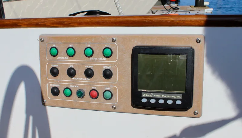 Slide: The Image of Control panel on a 2018 Cape George 45 sailboat, featuring buttons and a display screen. - 34