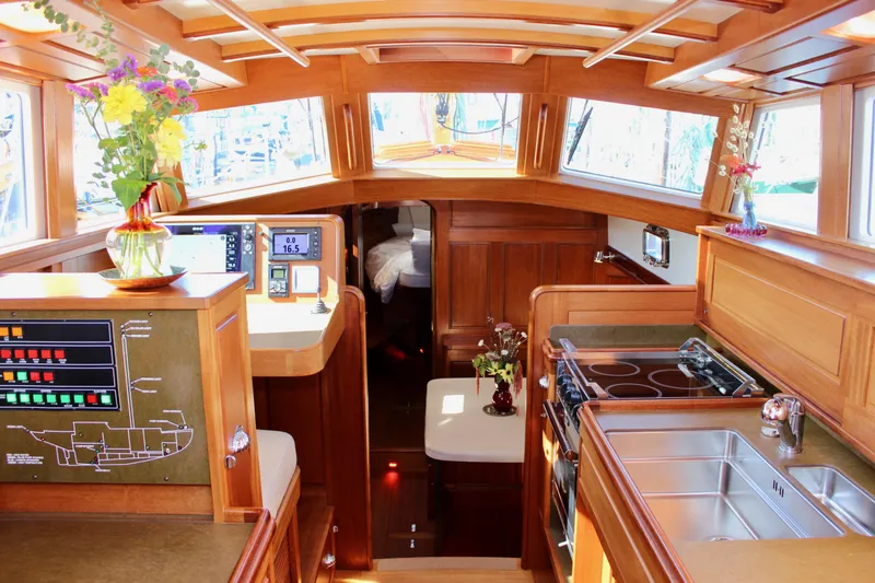 Slide: The Image of Luxurious 2018 Cape George 45 yacht interior with wood finish, modern kitchen, and navigation equipment. - 42