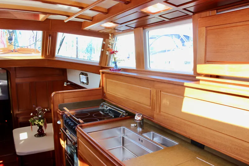 Slide: The Image of Luxurious wooden interior of 2018 Cape George 45 yacht kitchen with stove and sink. - 44