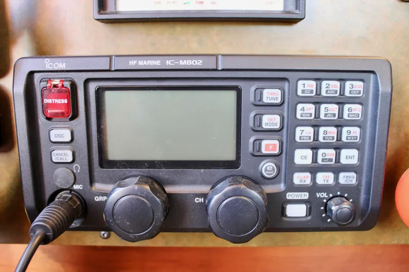 Slide: The Image of Marine radio equipment on a 2018 Cape George 45 sailboat, featuring distress button and controls. - 47
