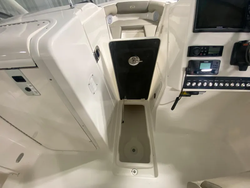 Slide: The Image of 2024 Key West 239 DFS boat interior with storage compartment and control panel. - 20