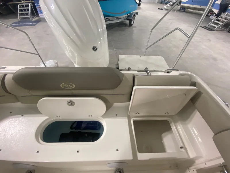 Slide: The Image of 2024 Key West 239 DFS boat interior with storage compartments and seating. - 6
