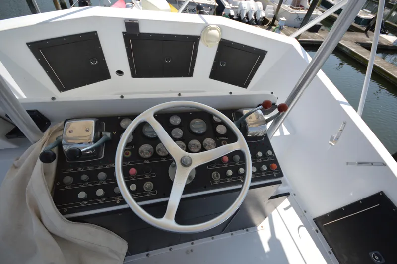 Slide: The Image of 1973 Hatteras 45 Convertible boat helm with steering wheel and control panel. - 10