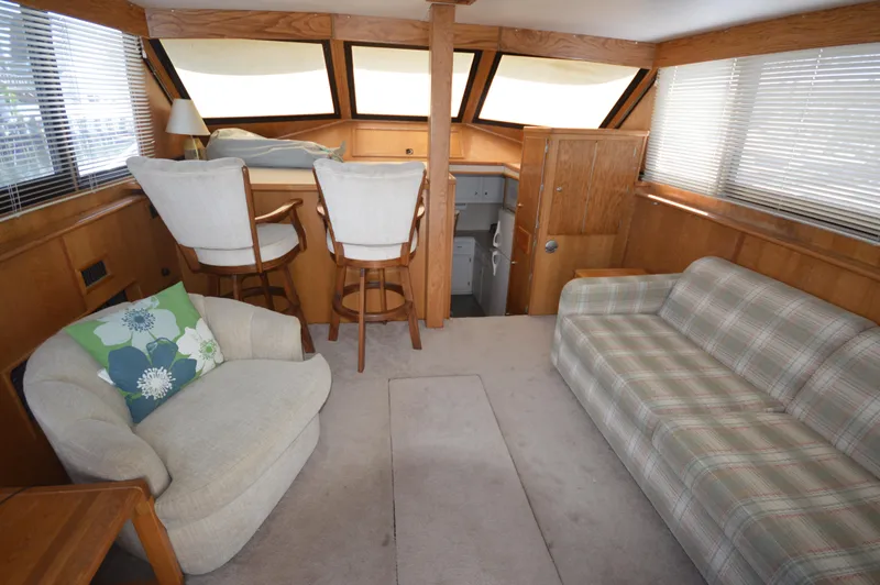 Slide: The Image of Interior of 1973 Hatteras 45 Convertible yacht with seating area and helm station. - 14