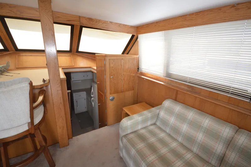 Slide: The Image of Interior of 1973 Hatteras 45 Convertible yacht with plaid sofa and wooden cabinetry. - 15