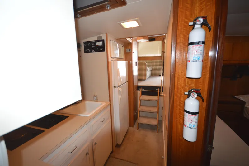 Slide: The Image of Interior of 1973 Hatteras 45 Convertible yacht with kitchen and stairs to cabin. - 22