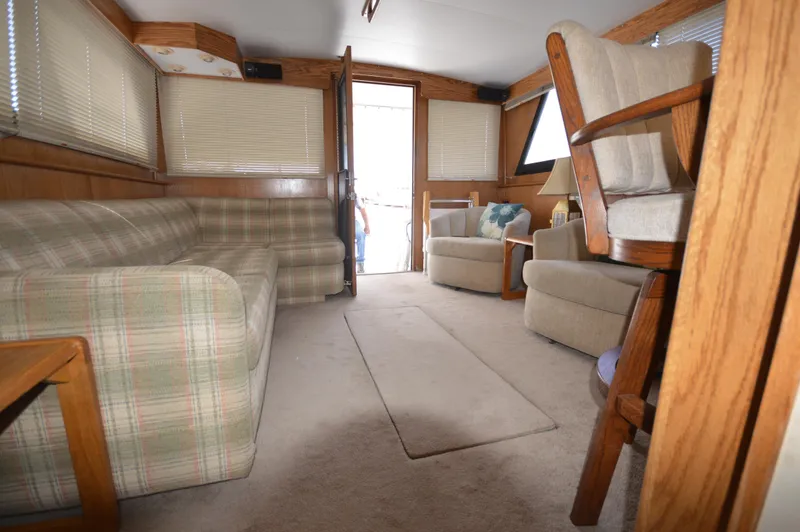 Slide: The Image of Interior of 1973 Hatteras 45 Convertible yacht with cozy seating and wooden accents. - 26
