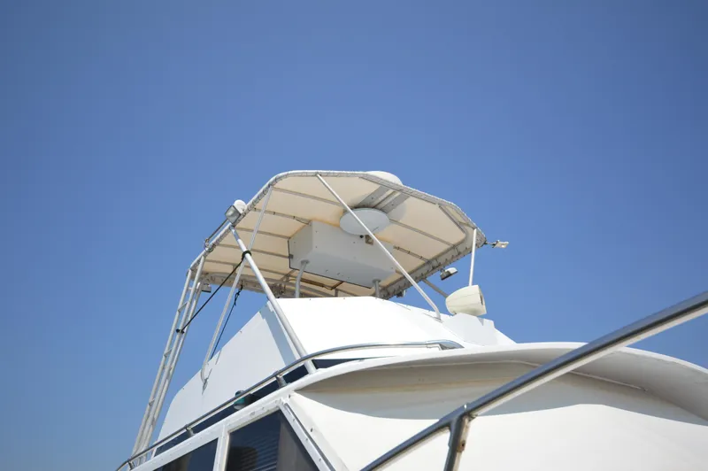 Slide: The Image of 1973 Hatteras 45 Convertible boat against clear blue sky. - 3
