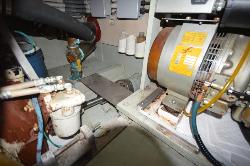 Slide: The Image of Engine room of a 1973 Hatteras 45 Convertible boat showing machinery and components. - 32