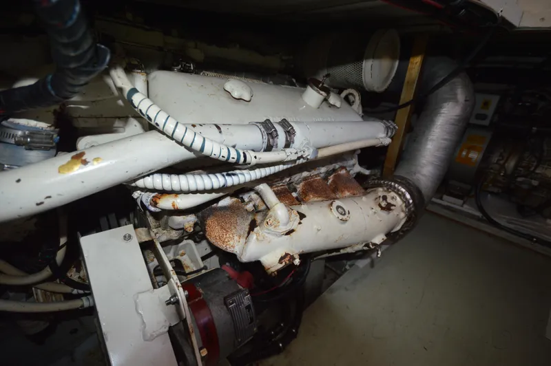 Slide: The Image of Engine room of a 1973 Hatteras 45 Convertible boat showing mechanical components. - 34