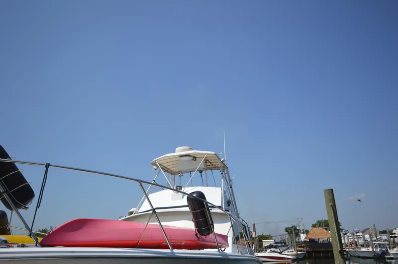 Slide: The Image of 1973 Hatteras 45 Convertible boat docked under clear blue sky. - 4