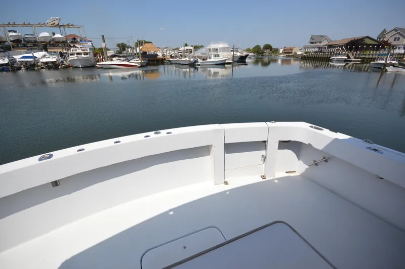 Slide: The Image of 1973 Hatteras 45 Convertible boat docked in a marina with calm waters. - 7
