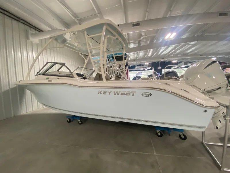 Slide: The Image of 2024 Key West 239 DFS boat displayed in a showroom. - 0