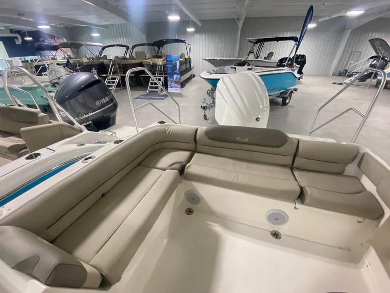 Slide: The Image of 2024 Key West 239 DFS boat interior with beige seating in showroom. - 7