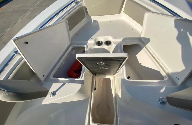 Slide: The Image of 2023 Key West 239 FS boat with open storage compartments and seating area. - 22