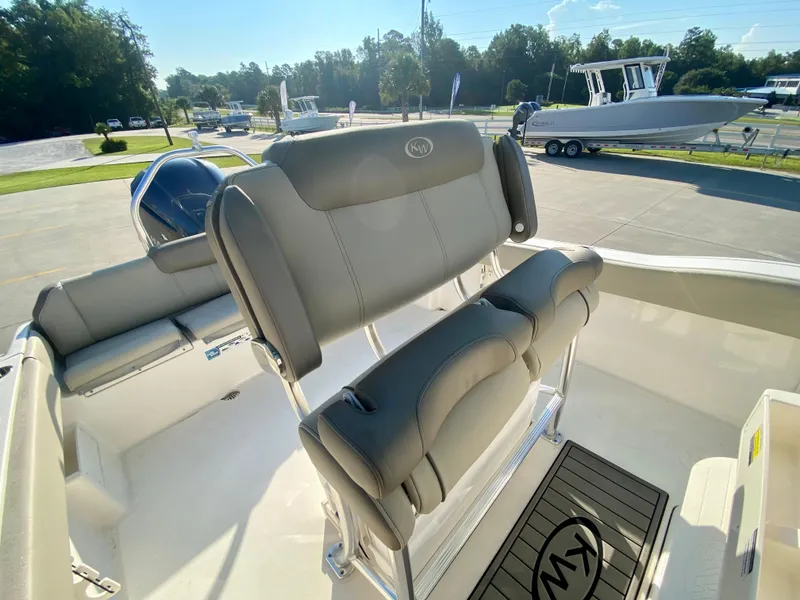 Slide: The Image of 2023 Key West 239 FS boat interior with cushioned seating and helm station. - 10