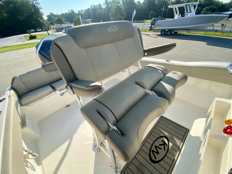 Slide: The Image of 2023 Key West 239 FS boat interior with cushioned seating and helm station. - 11
