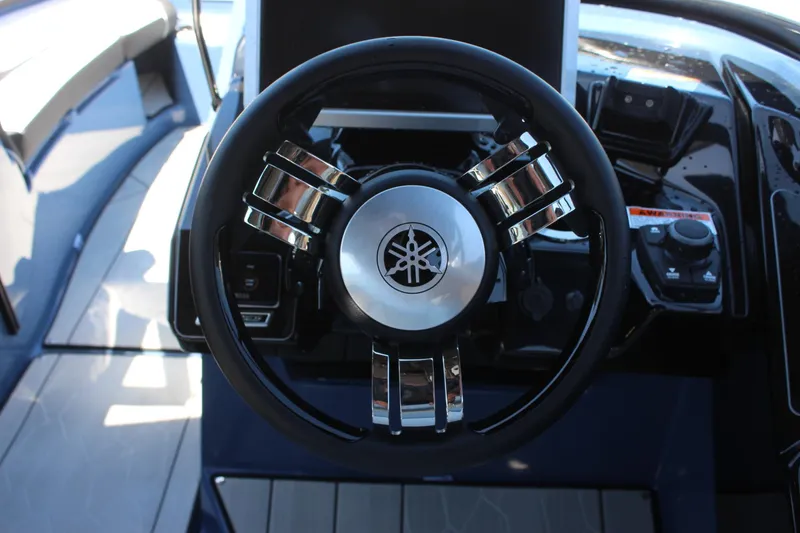 Slide: The Image of Steering wheel of 2023 Yamaha Boats 255XD, showcasing modern design and controls. - 12