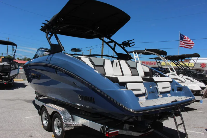 Slide: The Image of 2023 Yamaha Boats 255XD, blue, on trailer, rear view. - 2