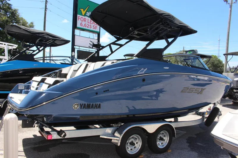 Slide: The Image of 2023 Yamaha Boats 255XD on trailer, sleek design, blue exterior, ready for water adventures. - 3