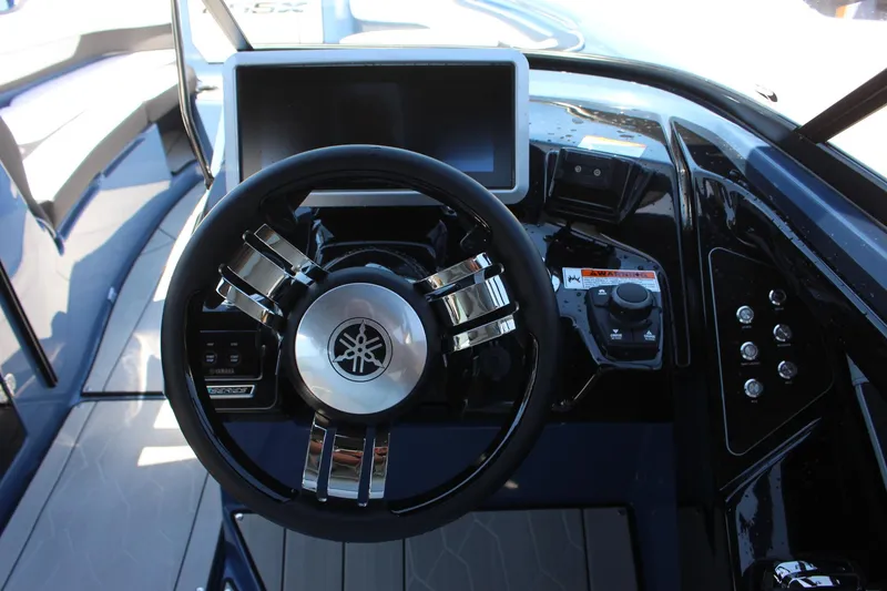 Slide: The Image of 2023 Yamaha Boats 255XD steering wheel and dashboard controls. - 9