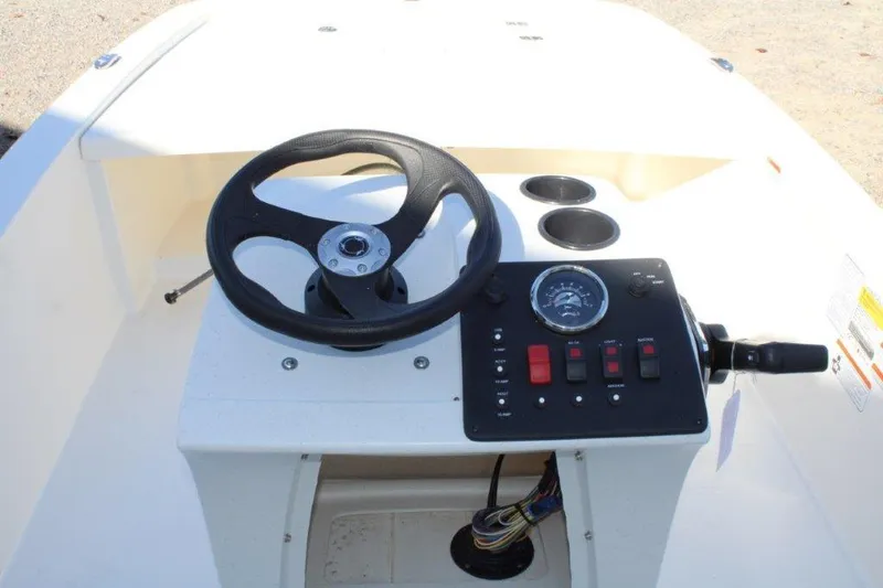 Slide: The Image of 2024 Mako Pro Skiff 13 CC console with steering wheel and control panel. - 4