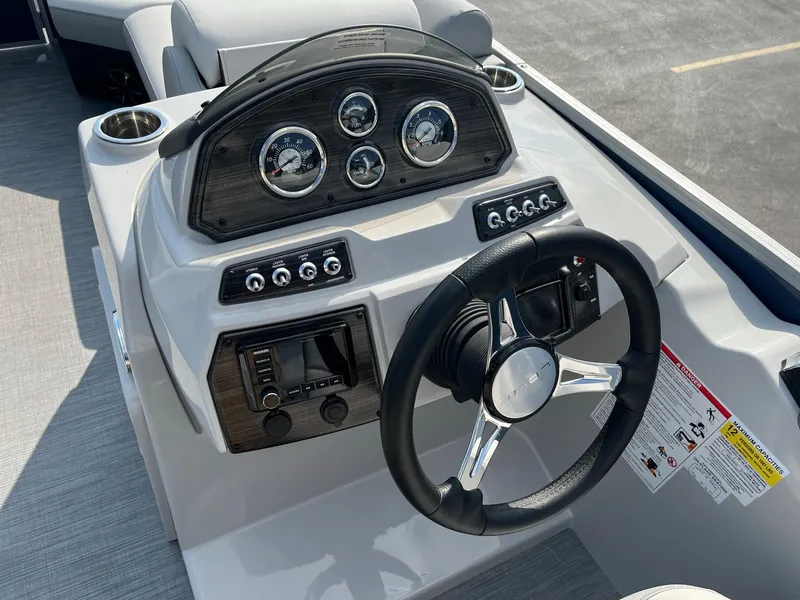 Slide: The Image of 2024 Lowe SS 210 WT boat dashboard with steering wheel and control panel. - 11