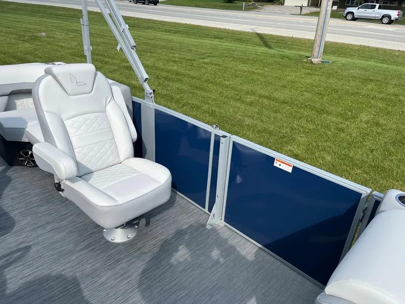 Slide: The Image of 2024 Lowe SS 210 WT boat interior with white captain's chair and blue side panels. - 13