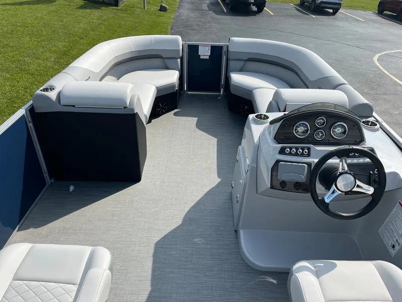 Slide: The Image of 2024 Lowe SS 210 WT pontoon boat interior with plush seating and modern dashboard. - 23