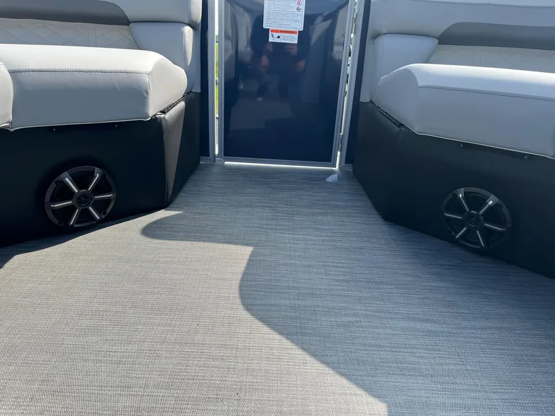Slide: The Image of Interior of 2024 Lowe SS 210 WT pontoon boat with cushioned seating and speakers. - 26