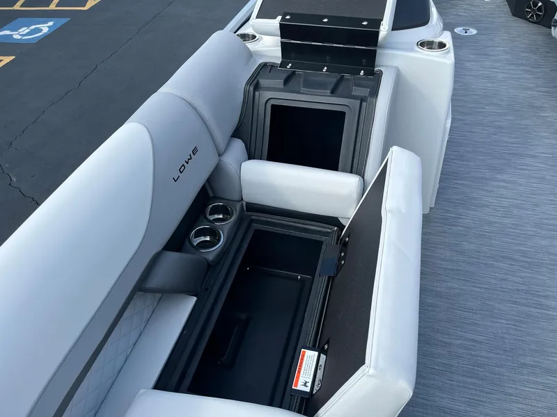 Slide: The Image of 2024 Lowe SS 210 WT boat with open storage compartments and cup holders. - 27