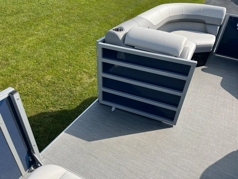 Slide: The Image of 2024 Lowe SS 210 WT pontoon boat interior with cushioned seating and open deck. - 28