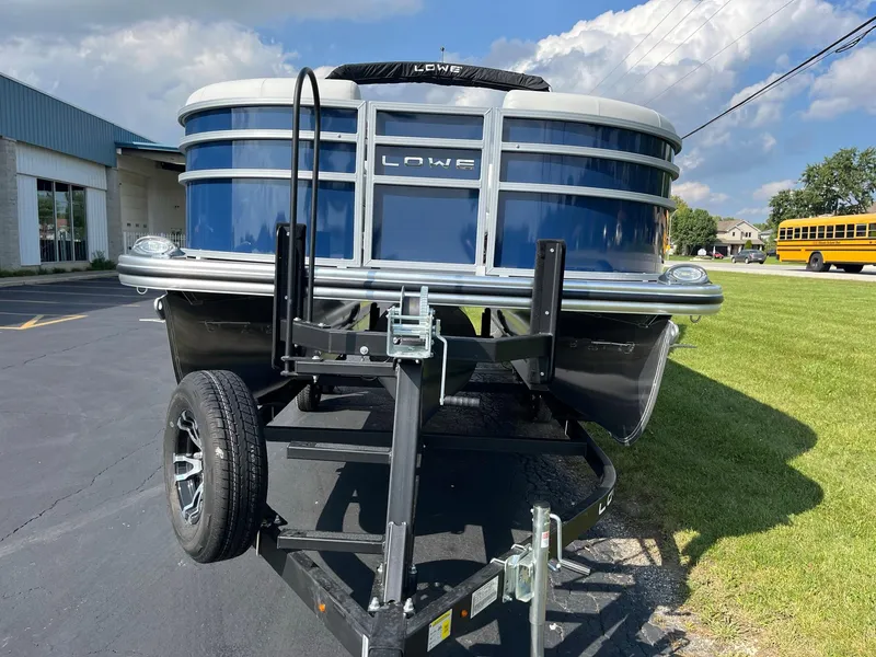 Slide: The Image of 2024 Lowe SS 210 WT pontoon boat on a trailer, front view. - 3